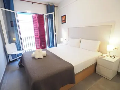a bedroom with a bed with two towels on it at Balcony View Apartment by Hello Homes Sitges in Sitges