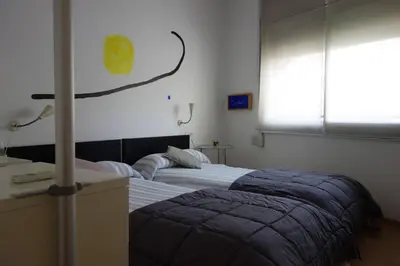 a bedroom with two beds and a window at Apartamento Noemi in Barcelona