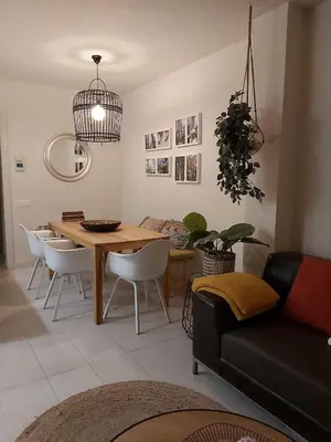 a living room with a dining room table and chairs at Casa Susana in Sitges