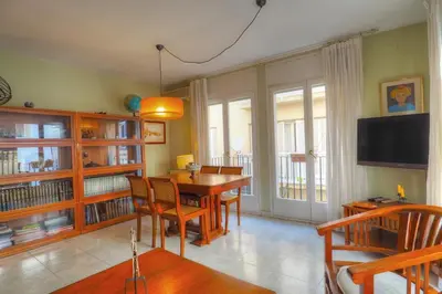 a dining room with a table and chairs and a television at Center Family Apartment by Hello Homes Sitges in Sitges