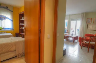a bedroom with a bed and a living room at Center Family Apartment by Hello Homes Sitges in Sitges