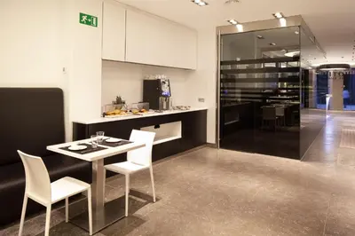 a kitchen with a table and chairs and a counter at Dalia Ramblas in Barcelona