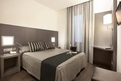 a hotel room with a bed and a window at Dalia Ramblas in Barcelona