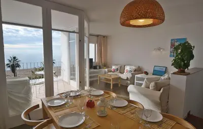 a living room with a table and a couch at Duplex en frente de la playa al lado de Barcelona in Canet de Mar