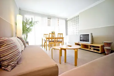 a living room with a couch and a table at Apartamento con Terraza, Balcón de Barcelona in Esplugues de Llobregat