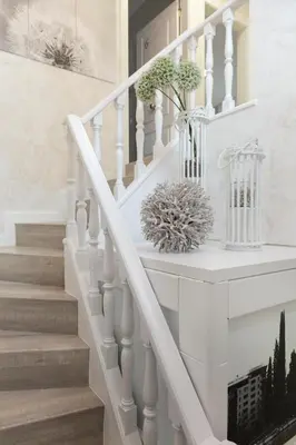 a white staircase with flowers in a vase on it at Urban Sabadell in Sabadell