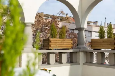 a balcony with two planters with plants on it at Urban Sabadell in Sabadell