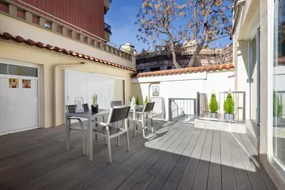 a patio with a table and chairs on a balcony at Urban Sabadell in Sabadell