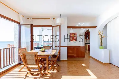 a dining room with a table and chairs on a balcony at Sitges Casa del Mar - Impresionantes vistas al mar in Sitges