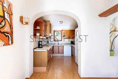 a kitchen with an archway in a house at Sitges Casa del Mar - Impresionantes vistas al mar in Sitges