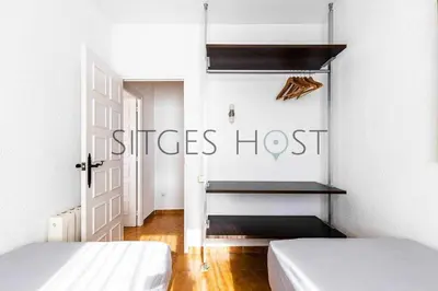 a room with two beds and a room with a door at Sitges Casa del Mar - Impresionantes vistas al mar in Sitges