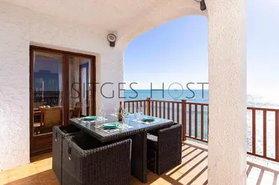 a table on a balcony with a view of the ocean at Sitges Casa del Mar - Impresionantes vistas al mar in Sitges