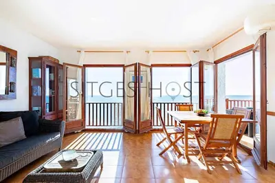 a living room with a couch and a table at Sitges Casa del Mar - Impresionantes vistas al mar in Sitges