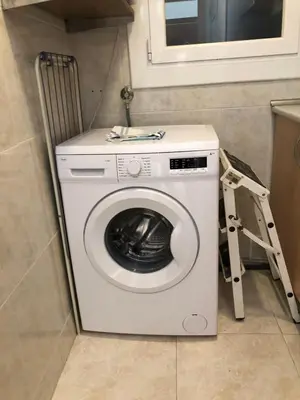 a washing machine in a room with a ladder at New! Apartment for 3 people near Fira Gran Via in Hospitalet de Llobregat