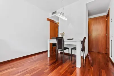 a dining room with a white table and chairs at Barcelona-Forum Apartments in Barcelona
