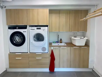 a kitchen with a washing machine and a sink at Villa Bella Vista in Castelldefels