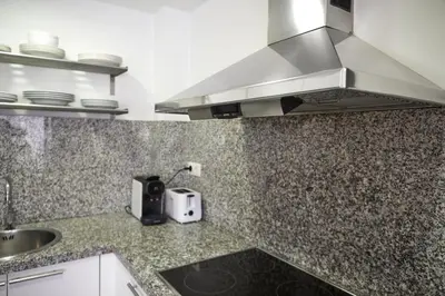 a kitchen with a sink and a counter top at SUN RAMBLA CATALUNYA GAUDI (Limpieza Desinfección) in Barcelona