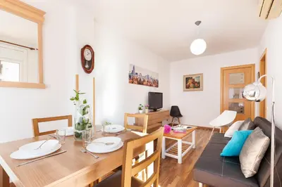a dining room and living room with a table and chairs at Click&Flat Fira Gran Via in Hospitalet de Llobregat