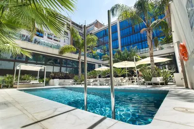a swimming pool in front of a building at Hotel Indigo Barcelona - Plaza Catalunya 4Sup by IHG in Barcelona