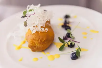 a white plate with a piece of food on it at Hotel Indigo Barcelona - Plaza Catalunya 4Sup by IHG in Barcelona