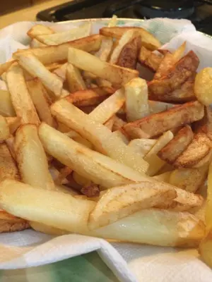 a pile of french fries sitting on a plate at CAN LLOBET Espai Rural Slow in Fogars de Montclus