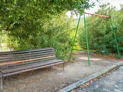 a park bench with a swing and a hoop at Cottage in Pacs near St Marti Sarroca Castle in Pacs del Penedes