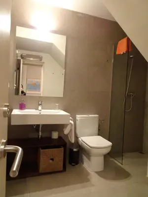 a bathroom with a toilet and a sink and a shower at Can Seuba in Rellinars