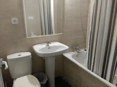 a bathroom with a sink and a toilet and a bath tub at Hostal River in Barcelona