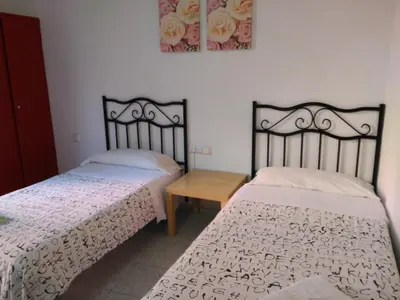 two beds sitting next to each other in a bedroom at Hostal River in Barcelona