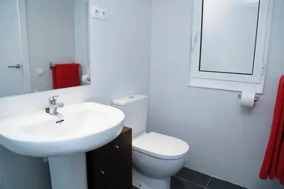 a bathroom with a sink and a toilet and a mirror at Sant Antoni Market in Barcelona