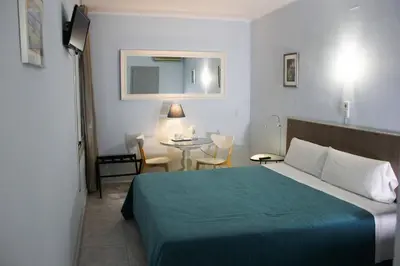 a hotel room with a bed and a table at Hotel Alexandra Sitges in Sitges