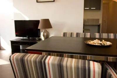 a plate of food on a table in a living room at Sant Pau Terraces Apartments in Barcelona