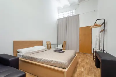 a bedroom with a bed and two chairs at CAMP NOU & FiRA BUSINESS LOFTS in Barcelona