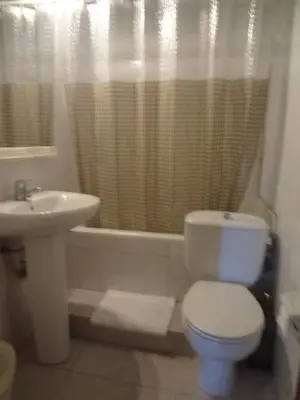 a bathroom with a toilet and a sink at Hostal Lima in Barcelona