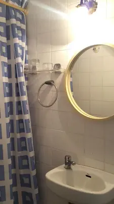 a bathroom with a sink and a mirror at Hostal Lima in Barcelona