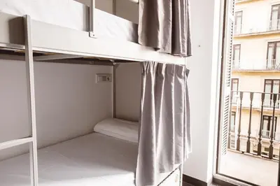 a bunk bed in a room with a window at St Christopher's Inn Barcelona in Barcelona