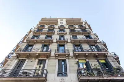 a tall building with balconies on the side of it at Quiet, Ultra-Central Stay KM0 for 3 in Barcelona