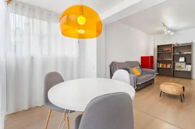 a living room with a white table and chairs at Quiet, Ultra-Central Stay KM0 for 3 in Barcelona