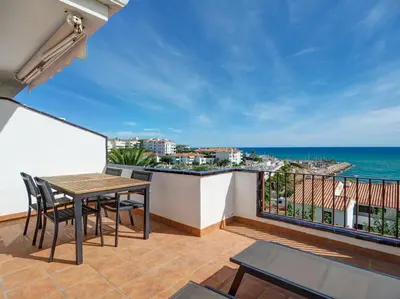 a balcony with a table and chairs and the ocean at Amazing Seaview Apartment by Hello Homes Sitges in Sitges