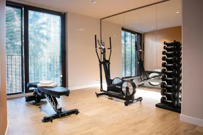 a gym with two exercise bikes and a mirror at MH Apartments Urban in Barcelona