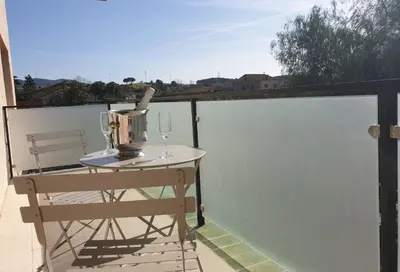 a table with a wine glass on a balcony at Hotel Consentido in Granollers