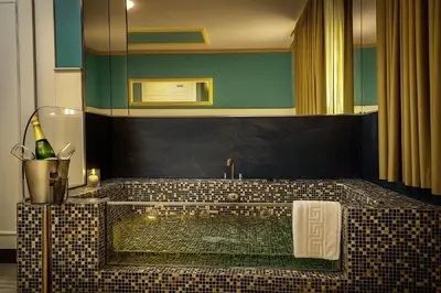 a bathroom with a bath tub with a sink at Hotel Consentido in Granollers
