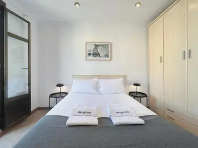 a bedroom with a large bed with two white pillows at Stay U-nique Apartments Calabria in Barcelona
