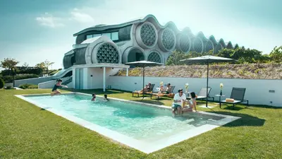 a group of people playing in a swimming pool at Mastinell Cava & Boutique Hotel by Olivia Hotels Collection in Vilafranca del Penedès