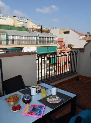 a table with food on top of a balcony at Pierre & Vacances Barcelona Sants in Barcelona