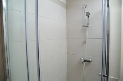 a shower stall with a glass door and a shower constructor at Pierre & Vacances Barcelona Sants in Barcelona
