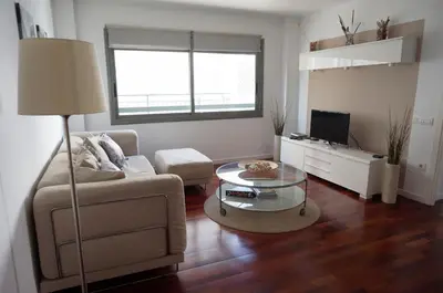 a living room with a couch and a table at Happy Holiday Beach Home in Sitges