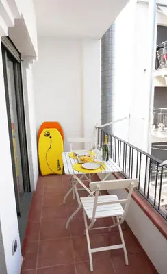 a balcony with a table and chairs on it at Happy Holiday Beach Home in Sitges