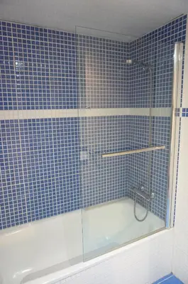 a blue tiled bathroom with a shower and a tub at Happy Holiday Beach Home in Sitges