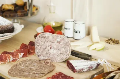 a cutting board with meats and cheese on a table at La Casa Gran B&B in Barcelona